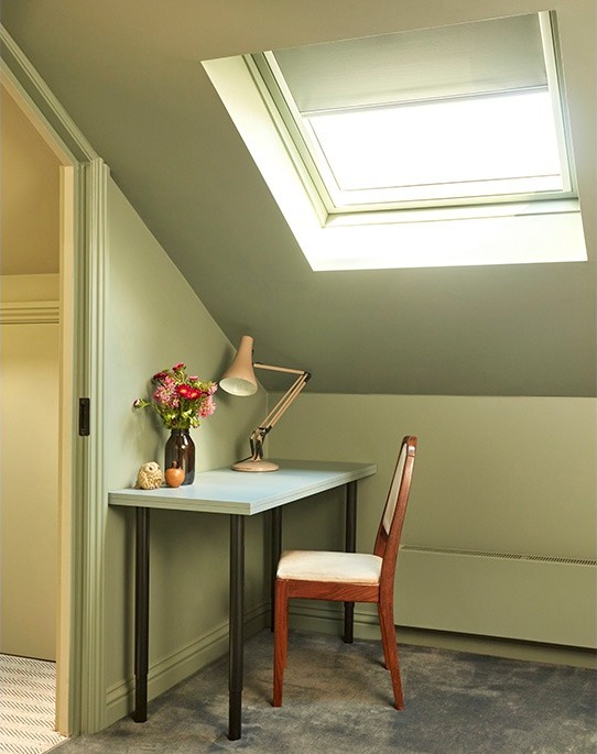 Loft study corner with desk, anglepoise lamp and roof window