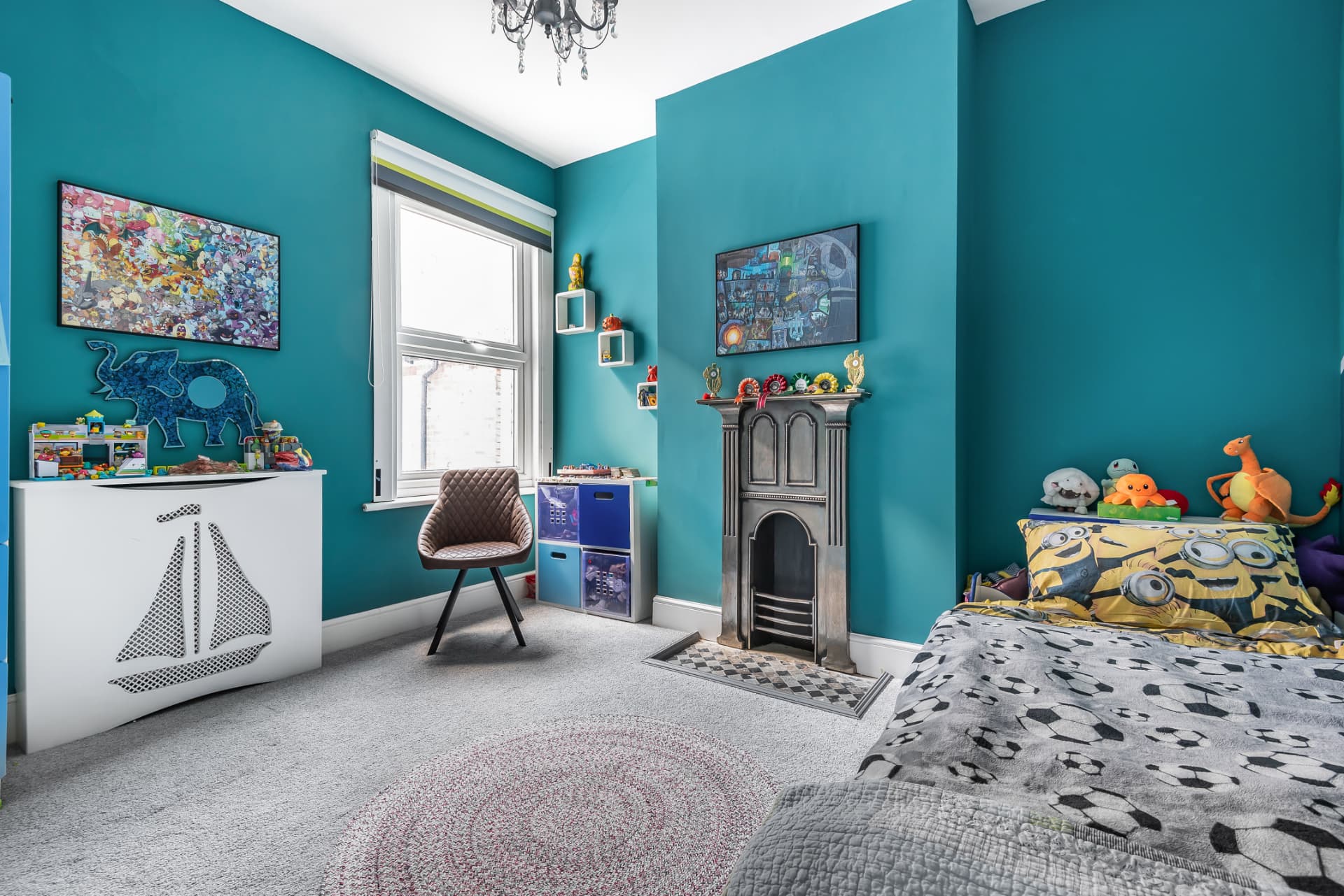 Child's bedroom with sailing boat radiator cover, toy storage and period fireplace