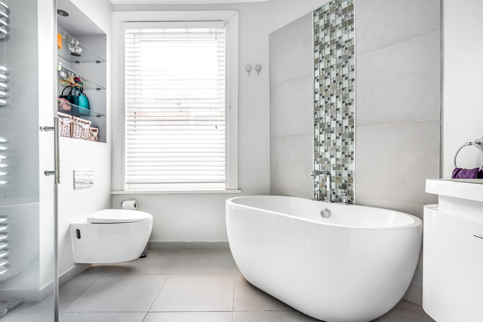 Family bathroom with freestanding bath, wall-hung toilet, mosaic feature strip and walk-in shower